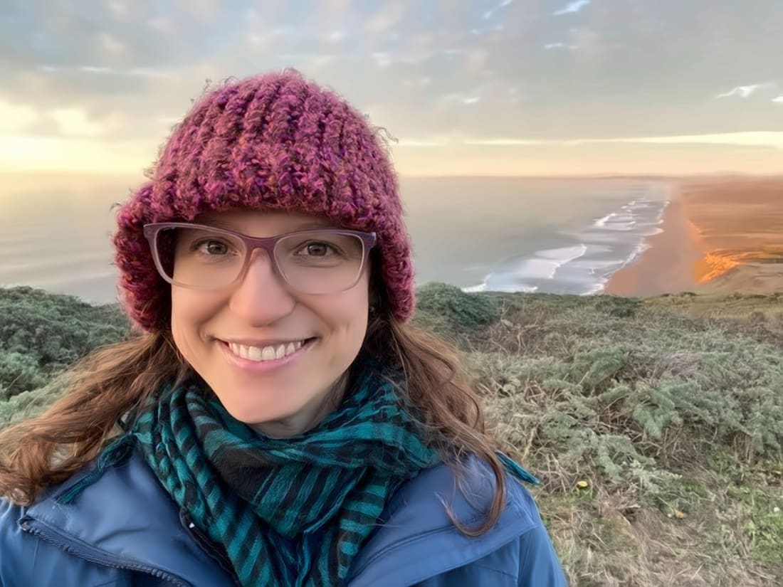 Susan Mackert, LCSW-R, smiling outdoors by the ocean